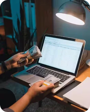 Business owner reconciling sales on a laptop